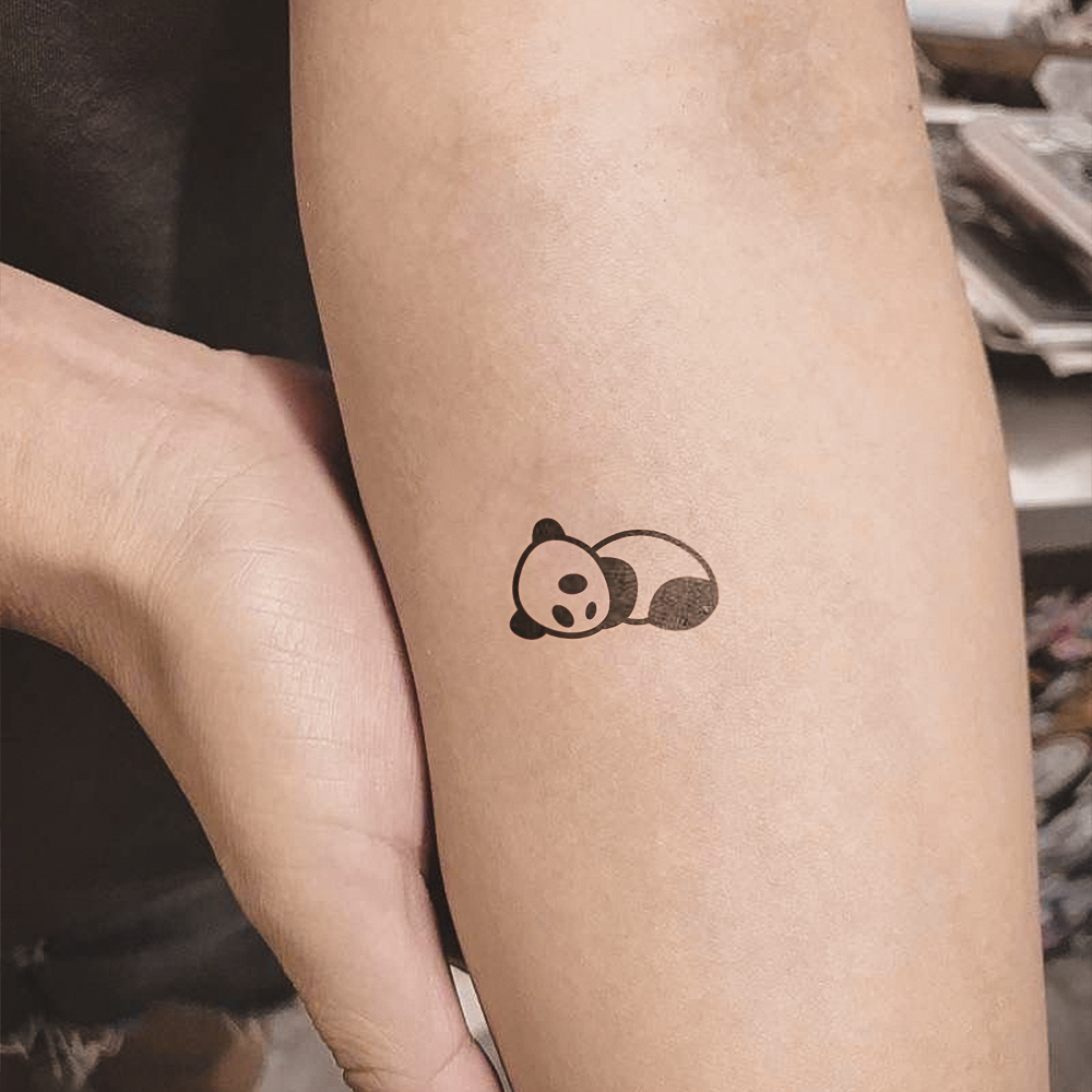 Small lying panda tattoo