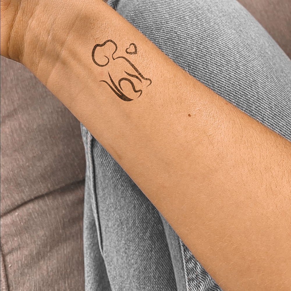 Dog and heart silhouette tattoo