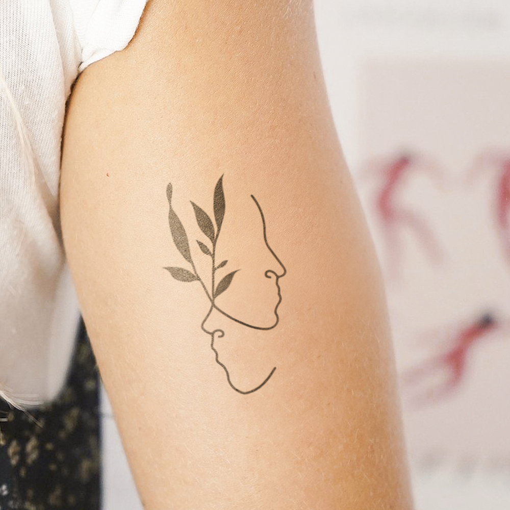 Faces and leaves tattoo