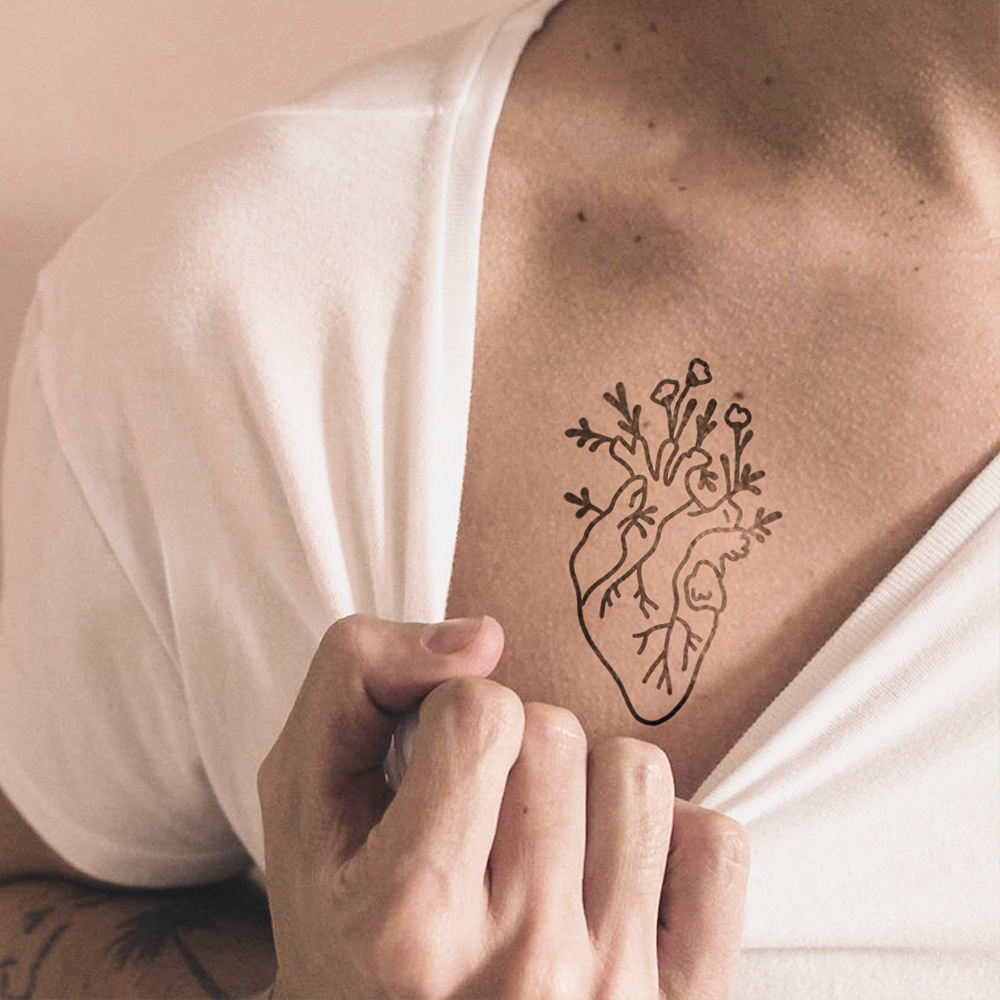 Realistic heart tattoo with flowers