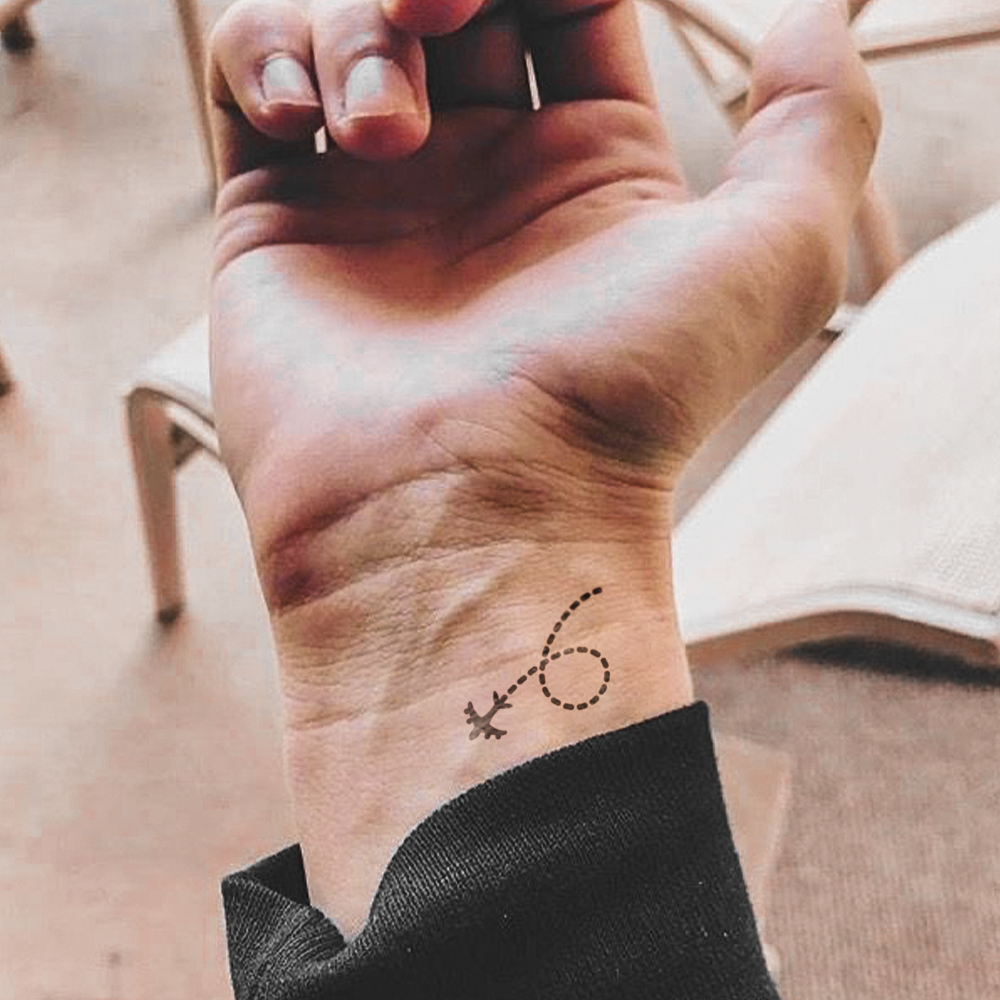 Flying airplane tattoo with dots